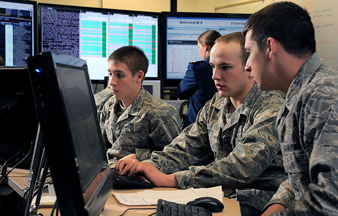 Cadet 1st Class Jordan Keefer, center, coordinates cadet efforts to defend their network during the National Security Agency's Cyber Defense Exercise April 17, 2012