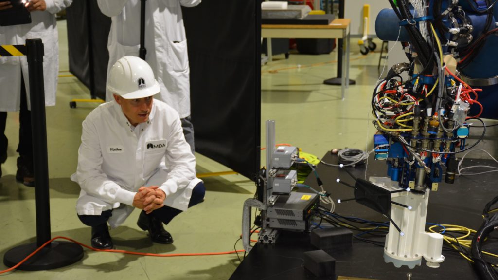 The Honourable François-Philippe Champagne, Minister of Innovation, Science and Industry examines some of MDA's technology. Credit: MDA.