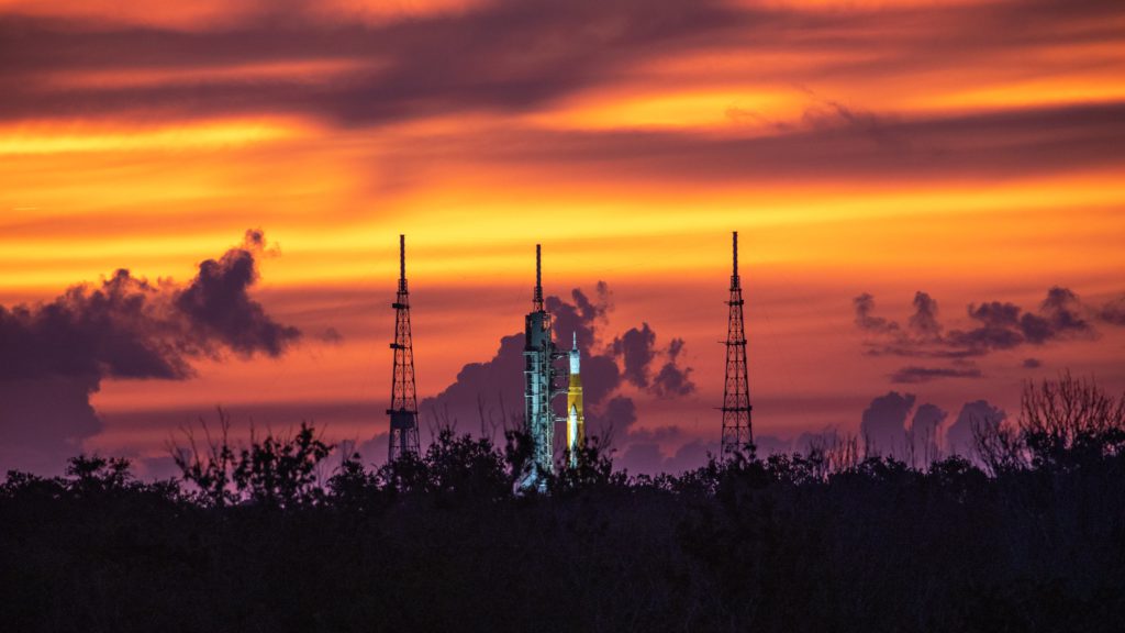 A golden sunrise surrounds NASA’s Space Launch System and Orion spacecraft for Artemis I on the pad at Launch Complex 39B at NASA’s Kennedy Space Center in Florida on Aug. 22, 2022. Credit: NASA.